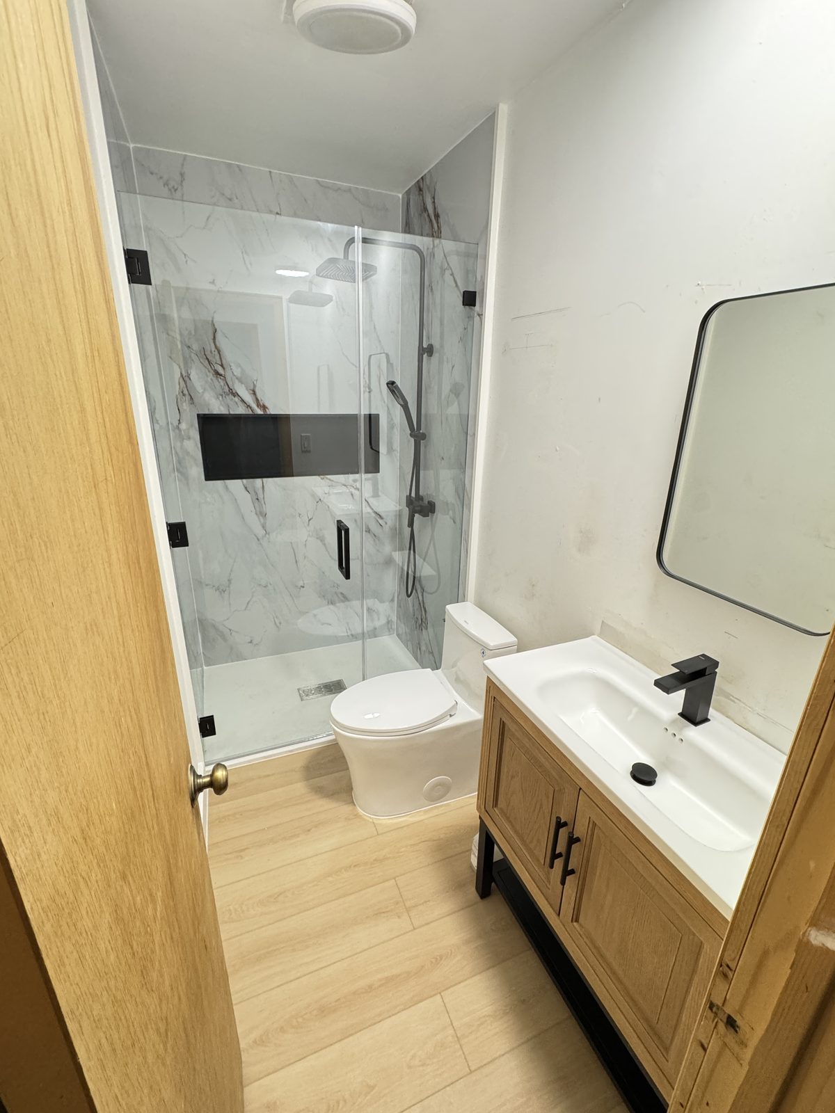 Corner shower and floating vanity